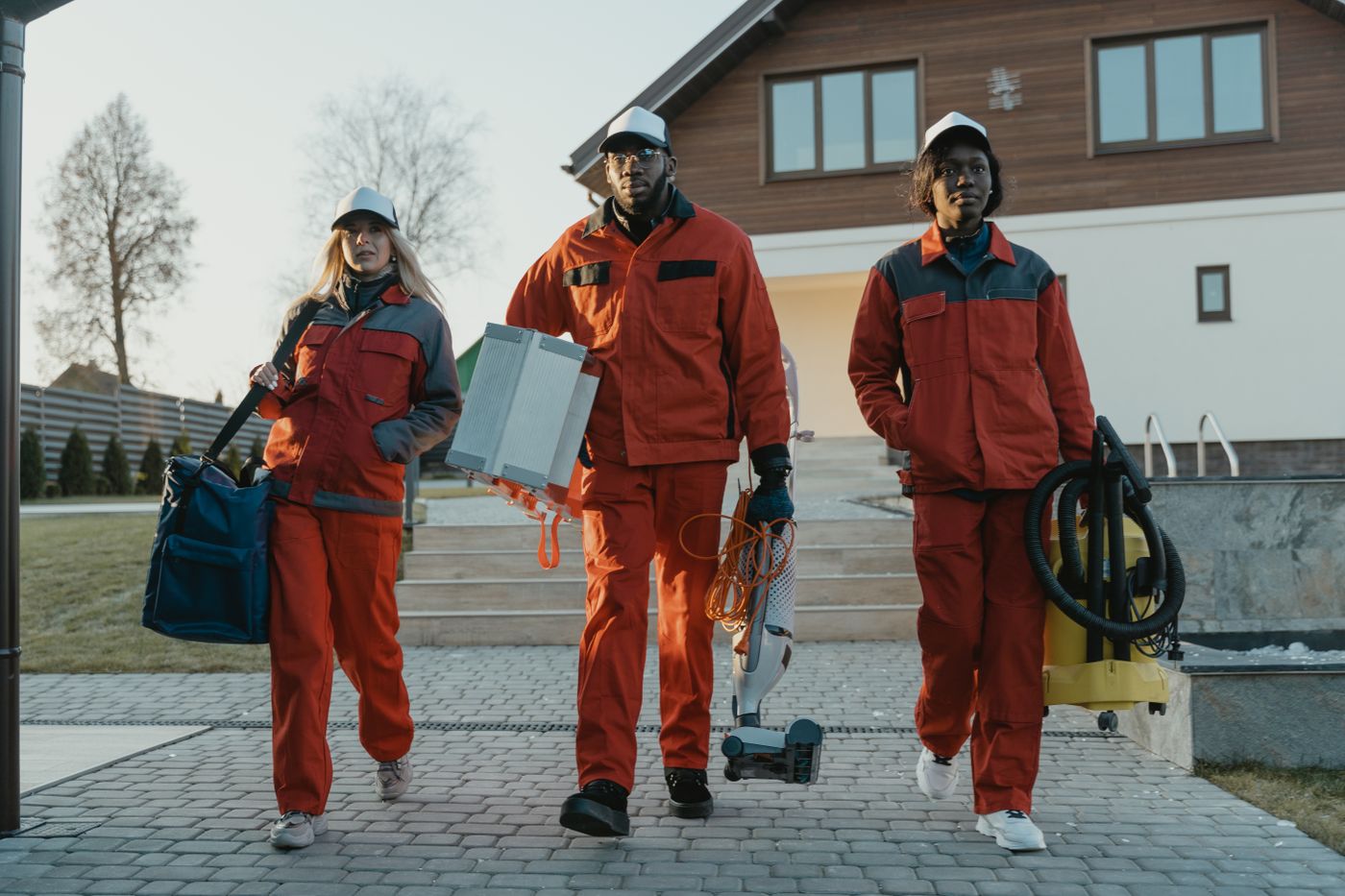cleaning 6196677 Cleaning professionals in overalls carrying cleaning equipment